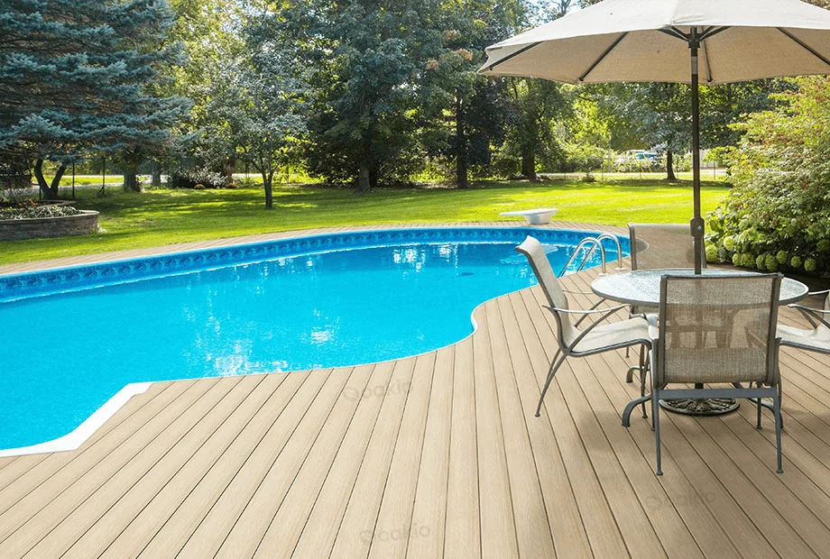 A composite deck system surrounds a beautiful swimming pool.