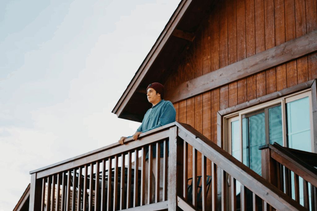 man standing on top of brown wooden deck
